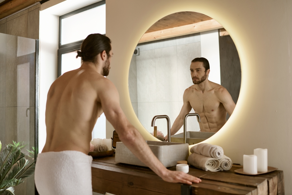 Selbstbild vs. Fremdbild: Mann sieht sich im Spiegel